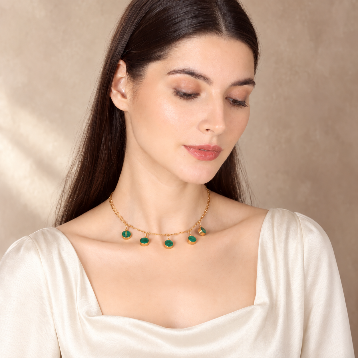 Woman wearing green gemstone necklace